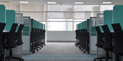 A row of empty workplace cubicles.