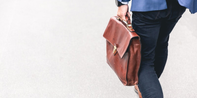 Man walking with brown briefcase.